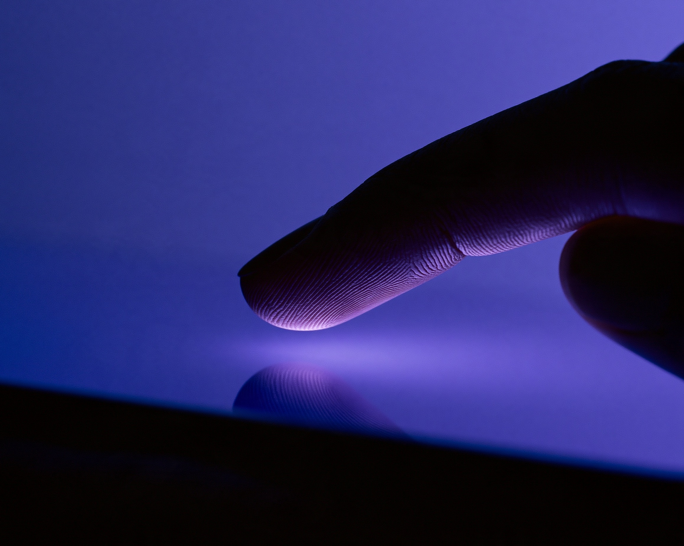 Macro studio photography of Black fingers testing interactive Telegram Mini App widget