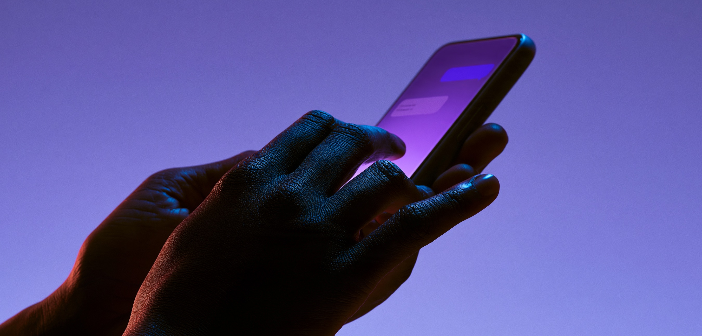 Black hands typing on smartphone with messaging chat interface